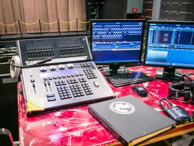 Computer monitors and other hardware used for managing stage sound and lighting.