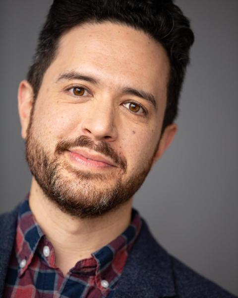 Adam Gwon in front of grey backdrop