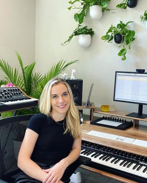 A color photograph of Merrily James sitting in front of a keyboard